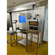 Un armadio per stampante industriale IP65 installato vicino ad un PC e ad una stazione di pesatura